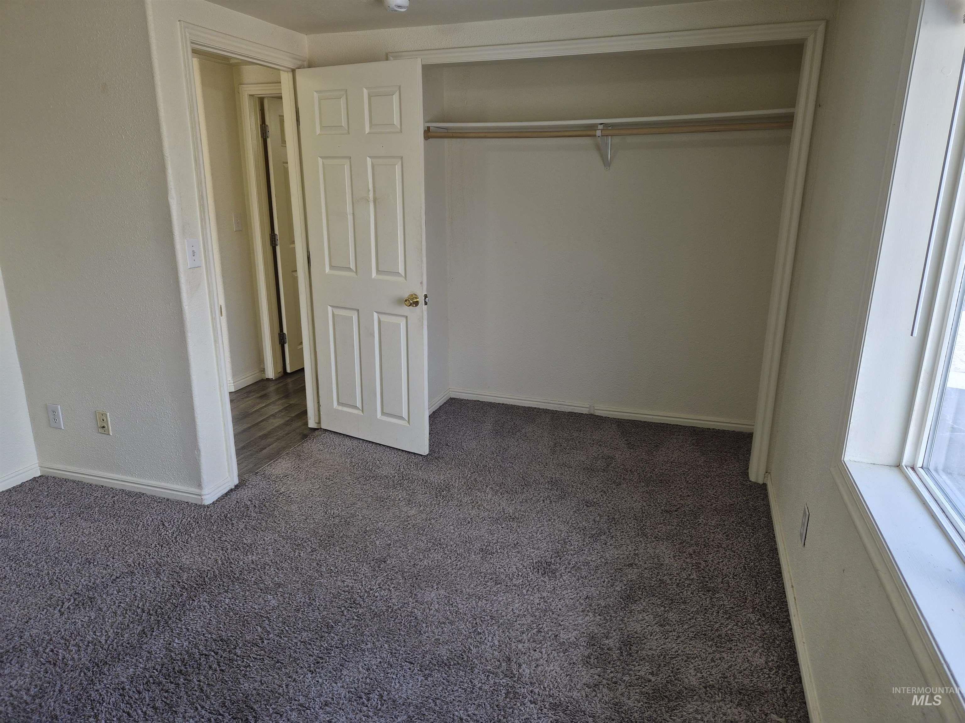 682 Randolph Avenue Pocatello, ID 83201 - Photo 8 of 29 Unfurnished bedroom featuring dark carpet and a closet