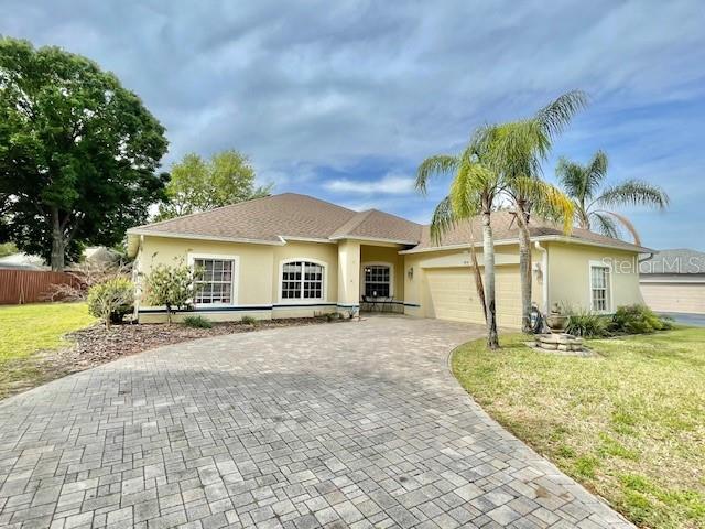 1818 Precious Circle Apopka, FL 32712 - Photo 1 of 1 a front view of a house with a yard and garage