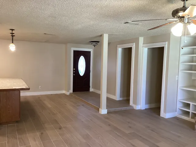 a view of kitchen with sink and refrigerator