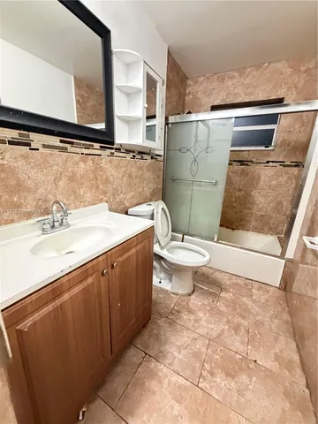 a bathroom with a sink a toilet and mirror