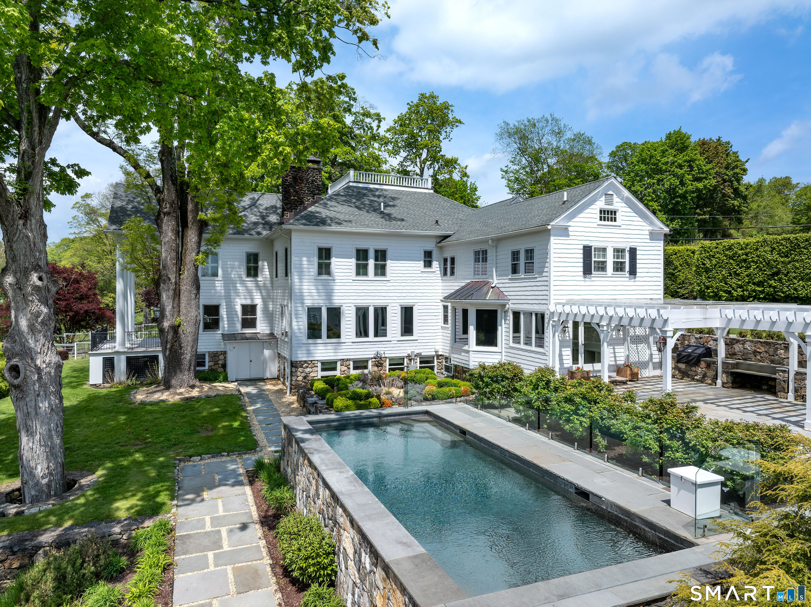 155 Long Ridge Road Danbury, CT 06810 - Photo 5 of 40 At the rear, the heated pool and stone terraces create a natural center for outdoor living and summer entertaining.