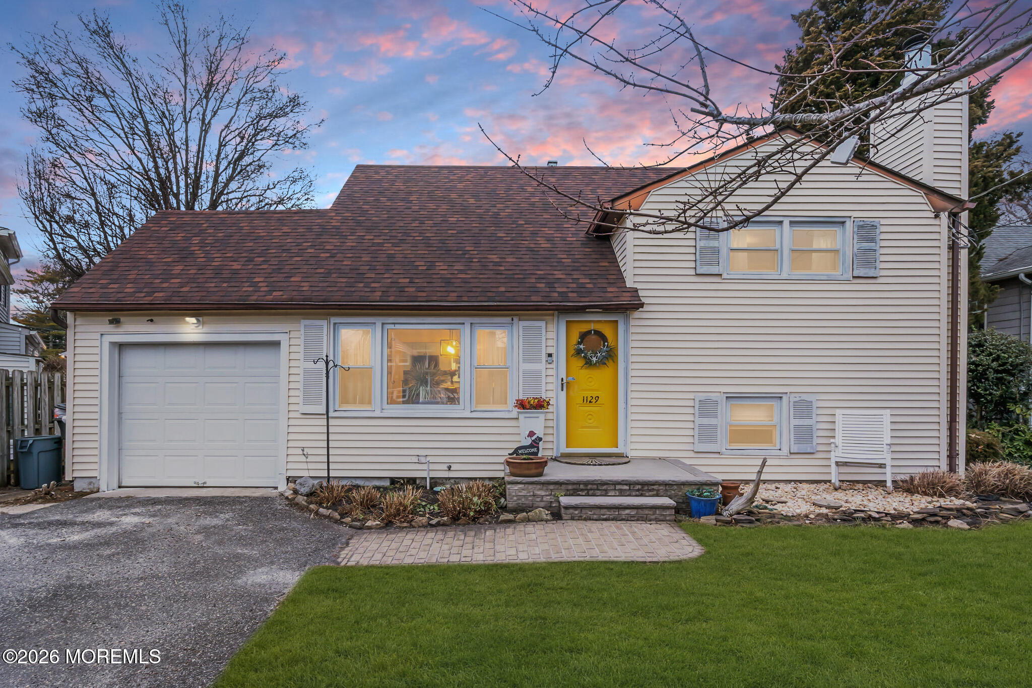 a front view of a house with a yard and outdoor seating