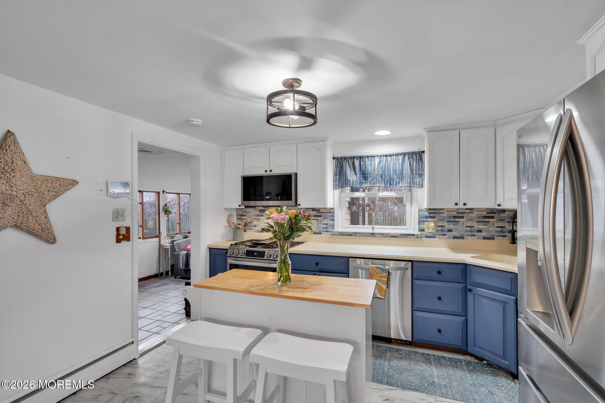 1129 Roe Avenue Point Pleasant, NJ 08742 - Photo 14 of 71 a living room with kitchen island granite countertop furniture and a flat screen tv