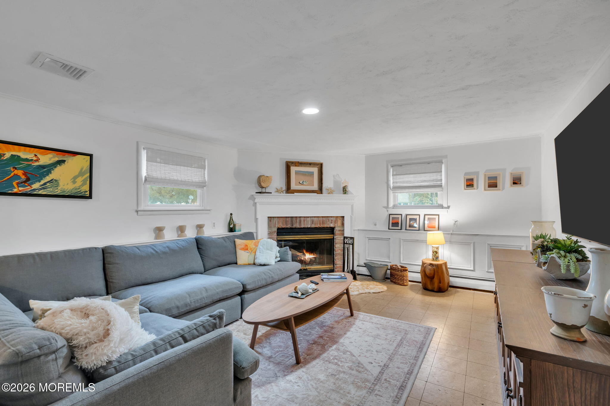 1129 Roe Avenue Point Pleasant, NJ 08742 - Photo 22 of 71 a living room with furniture a fireplace and a flat screen tv