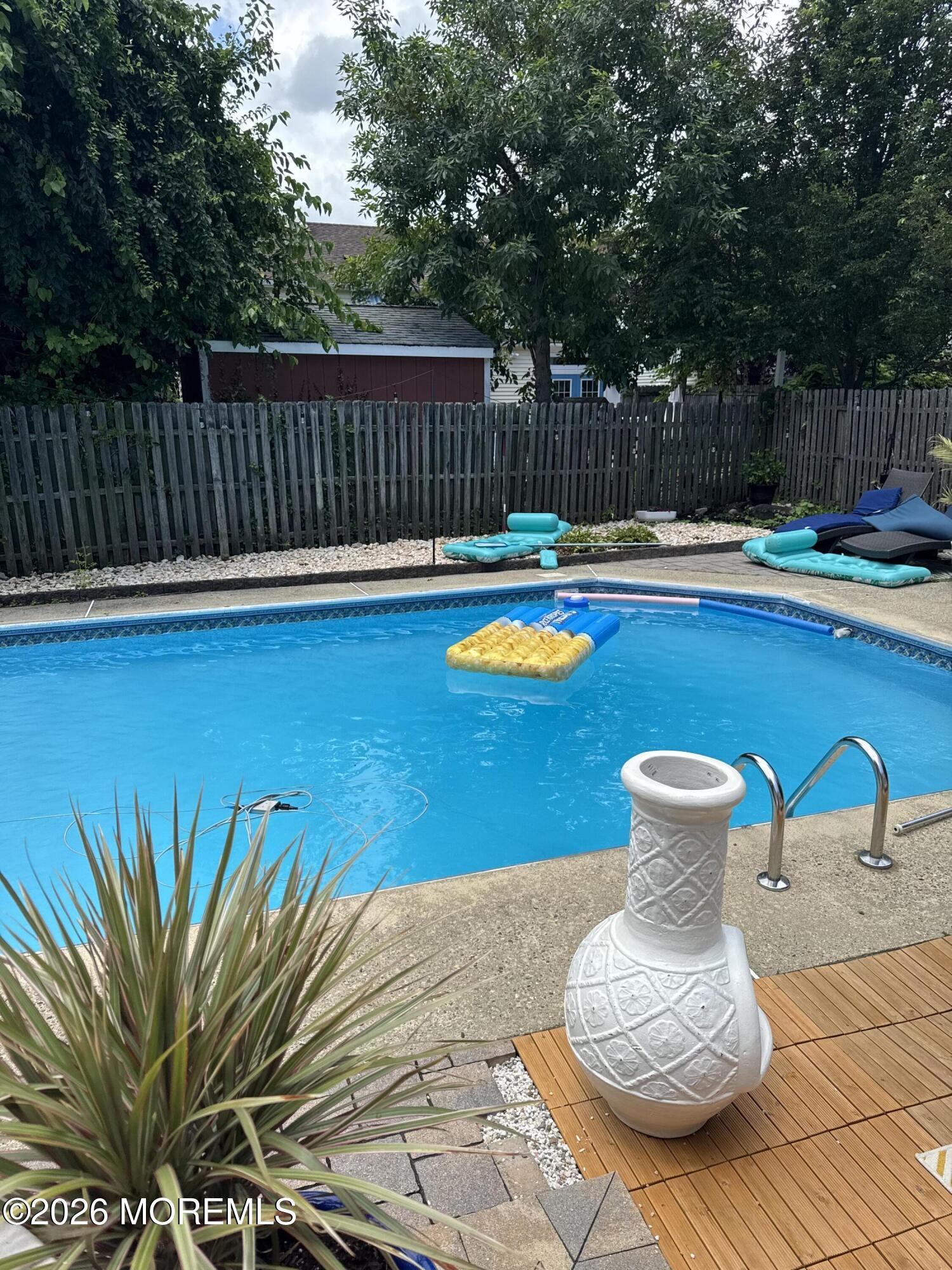 1129 Roe Avenue Point Pleasant, NJ 08742 - Photo 35 of 71 a view of a swimming pool with a lounge chair