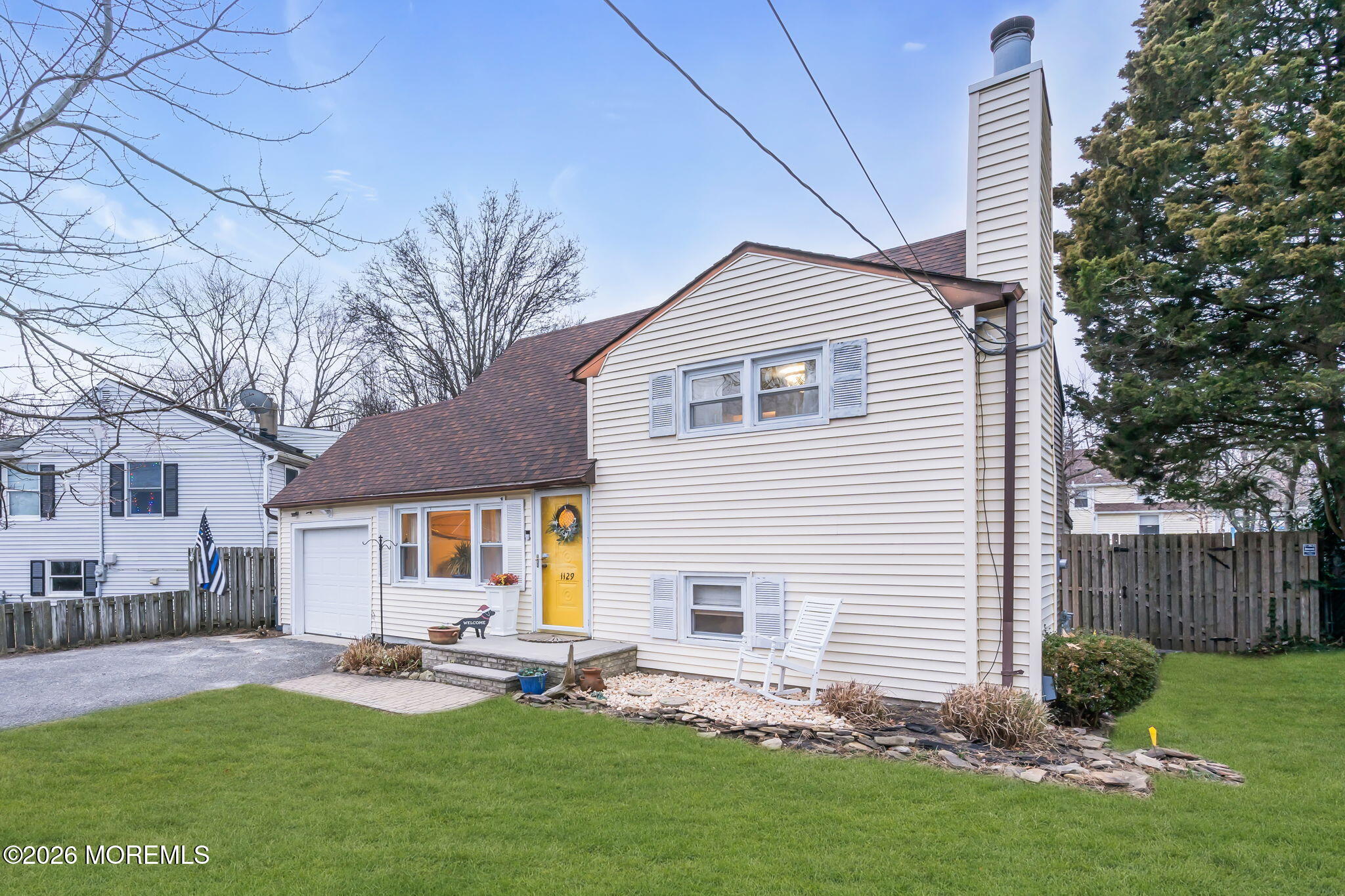 1129 Roe Avenue Point Pleasant, NJ 08742 - Photo 4 of 71 a backyard of a house with table and chairs and wooden fence