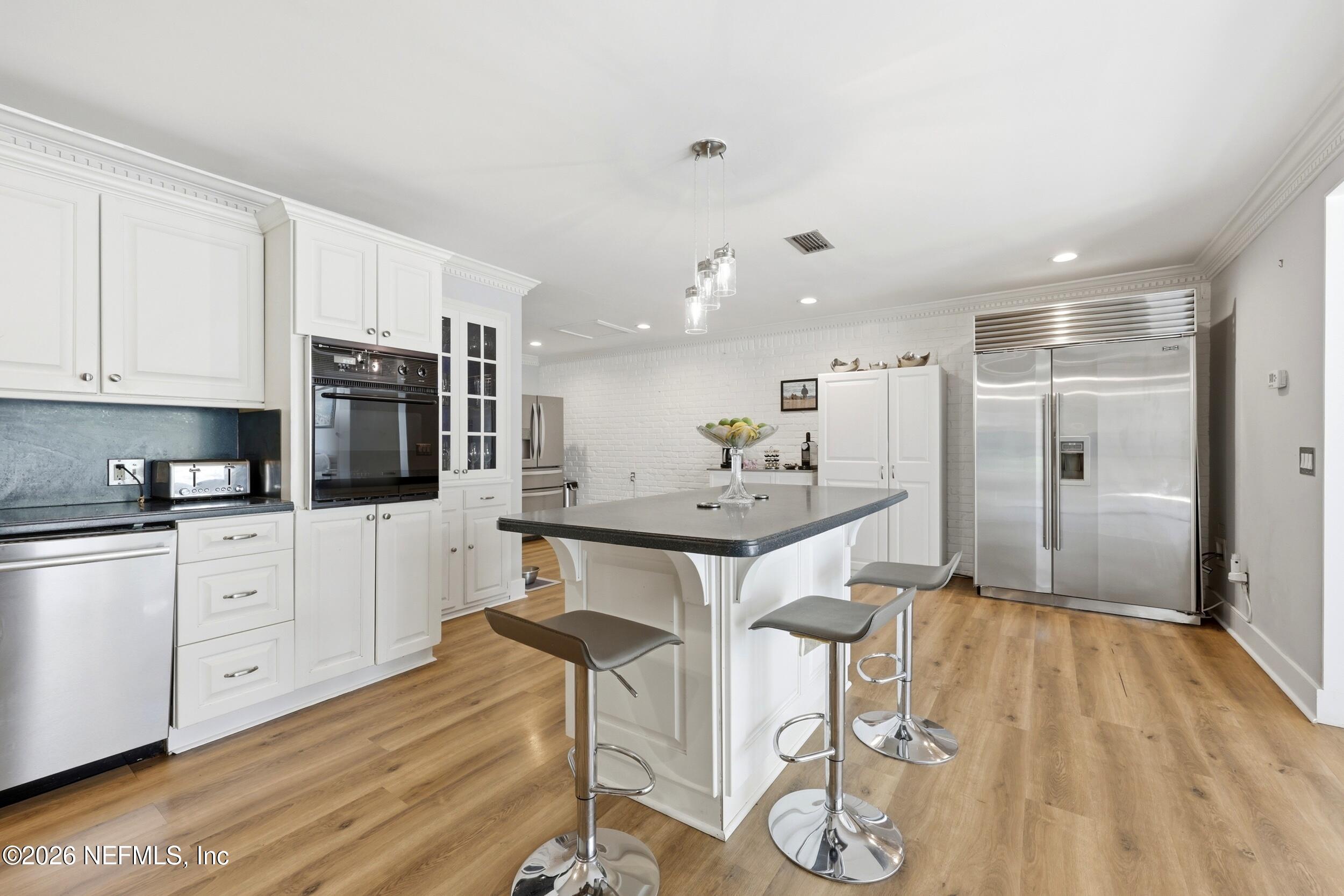 11627 Mandarin Terrace Road Jacksonville, FL 32223 - Photo 22 of 79 a kitchen with kitchen island granite countertop a sink cabinets and stainless steel appliances
