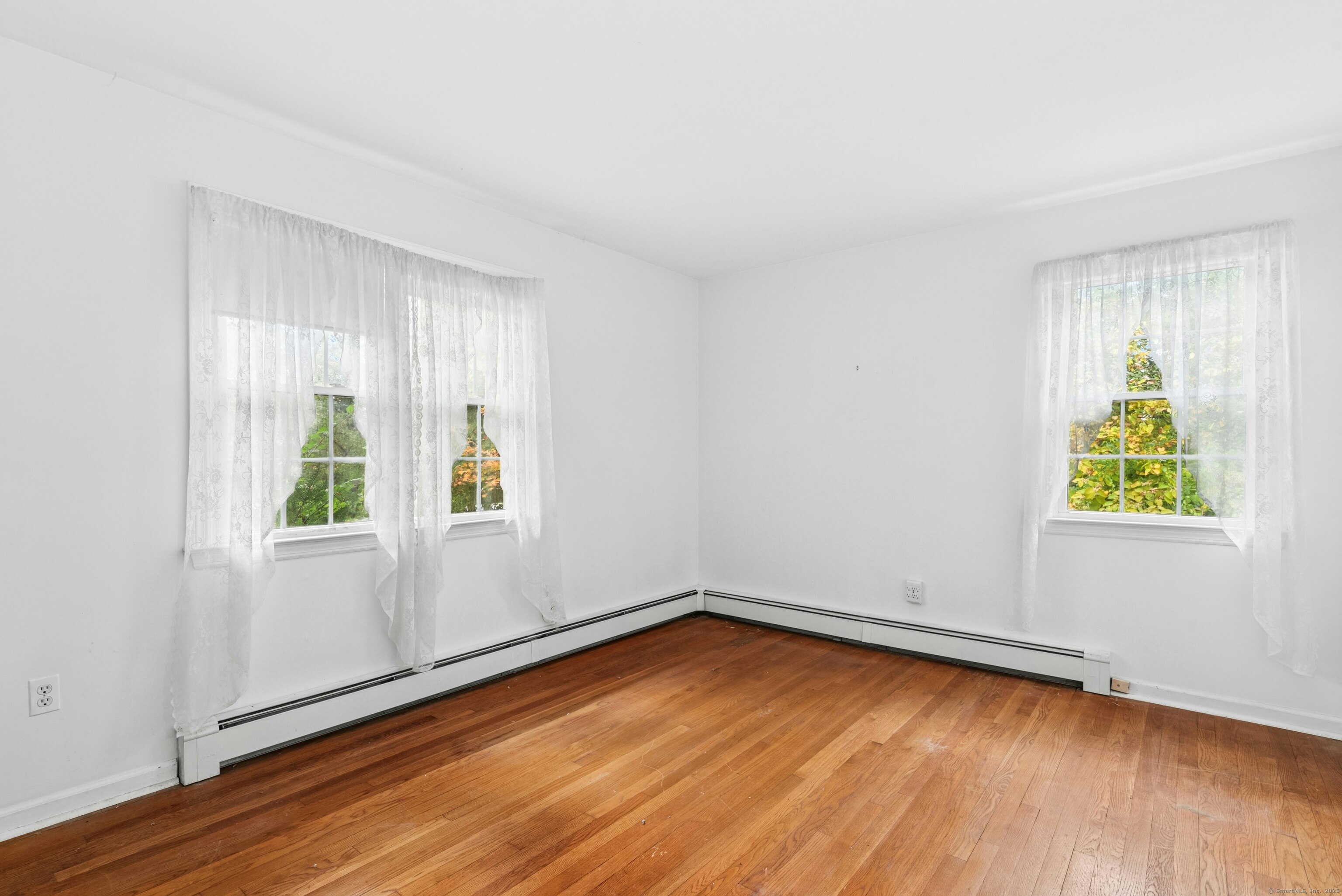 340 Moose Hill Road Monroe, CT 06468 - Photo 13 of 21 an empty room with wooden floor and windows
