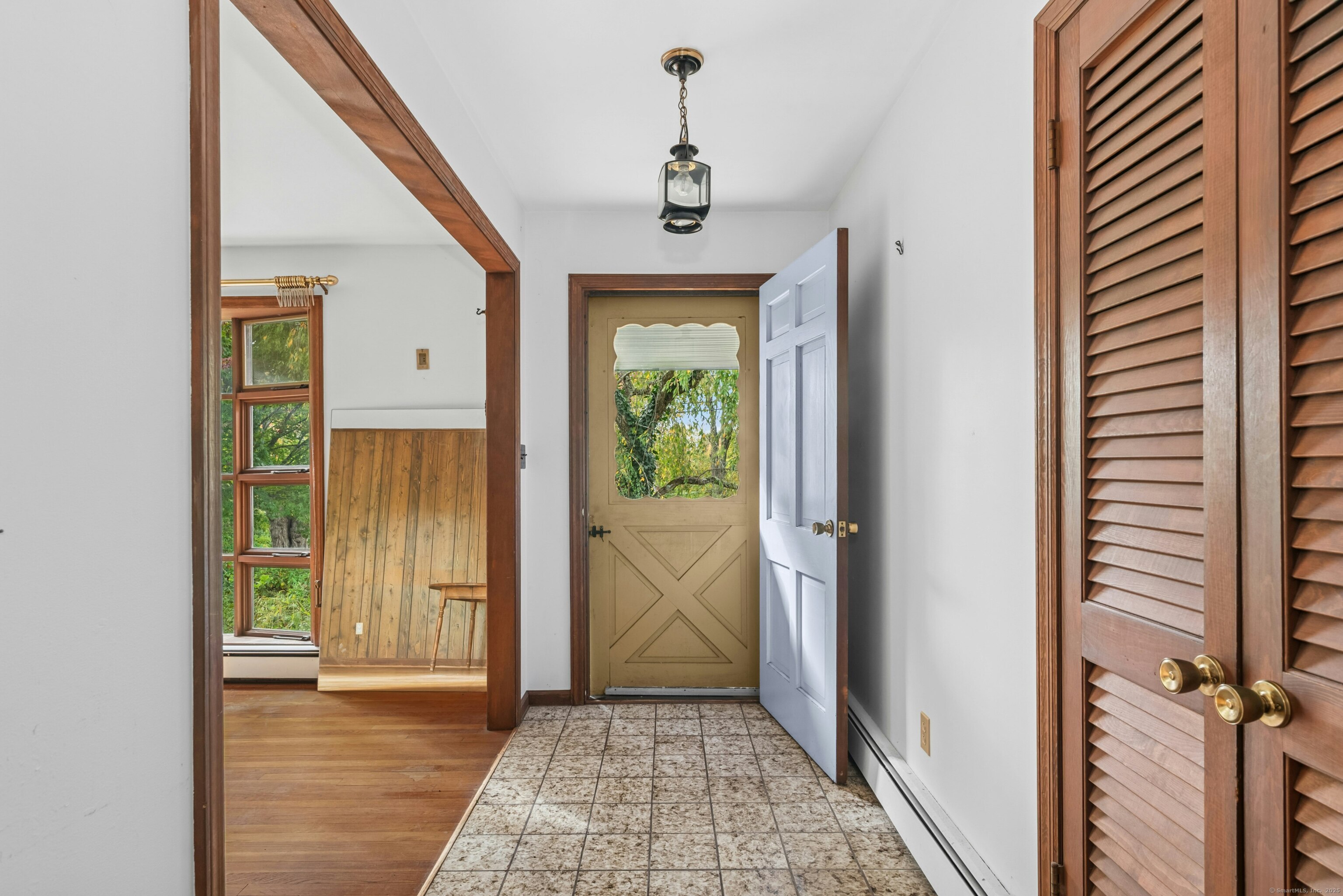 340 Moose Hill Road Monroe, CT 06468 - Photo 7 of 21 a view of a hallway with wooden floor and a bathroom