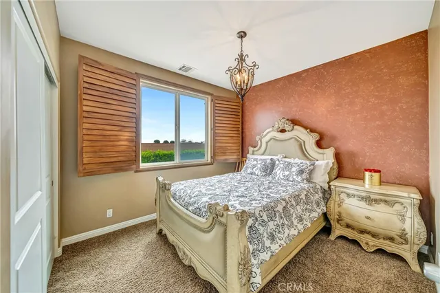 a dining hall with stainless steel appliances granite countertop a table chairs and a refrigerator