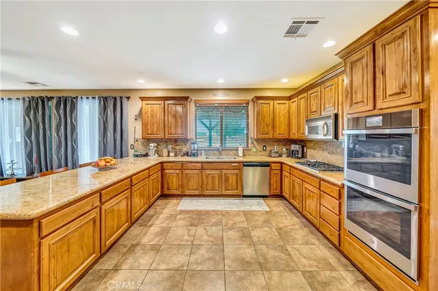 a spacious bathroom with a granite countertop sink a mirror and a shower