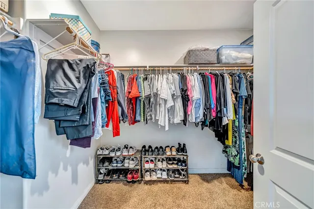 a view of a hallway with closet and a bathroom