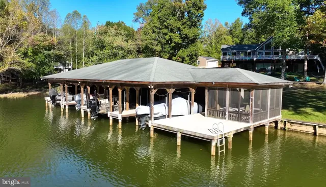 a view of swimming pool with chairs and table under an umbrella