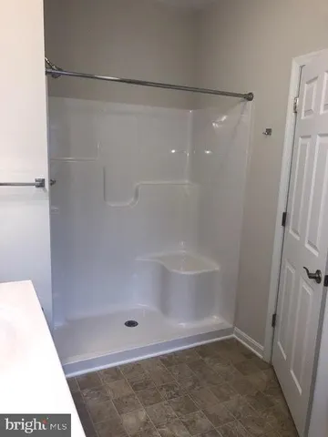 a bathroom with a sink toilet and window
