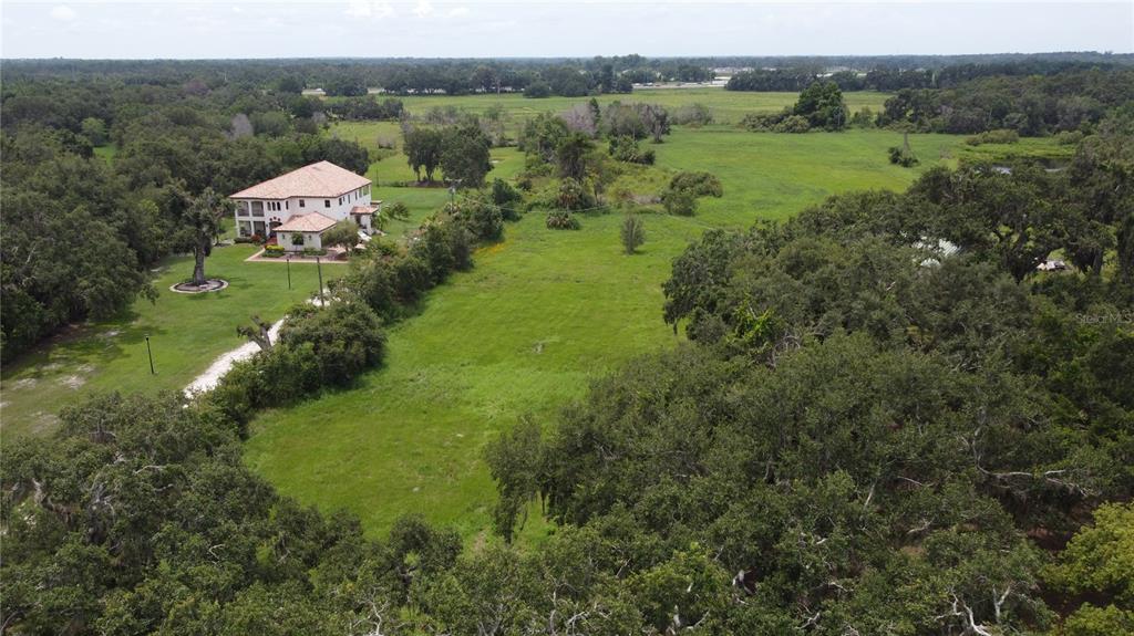 6501 Muck Pond Road Seffner, FL 33584 - Photo 11 of 21 an aerial view of green landscape with trees houses and mountain view