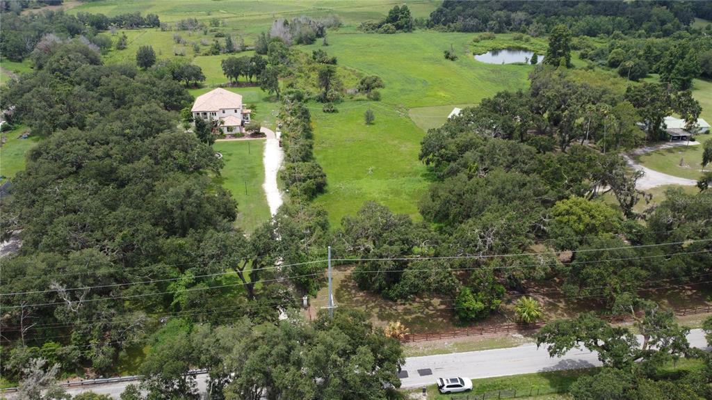6501 Muck Pond Road Seffner, FL 33584 - Photo 16 of 21 an aerial view of a house with outdoor space and trees all around
