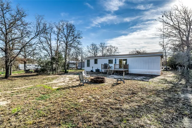 a view of a house with a yard and sitting area