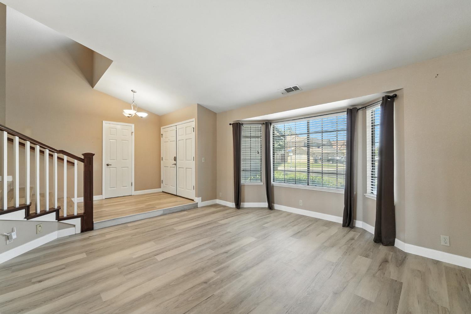 834 Cedar Ridge Drive Turlock, CA 95382 - Photo 12 of 57 a view of an empty room with wooden floor and a window