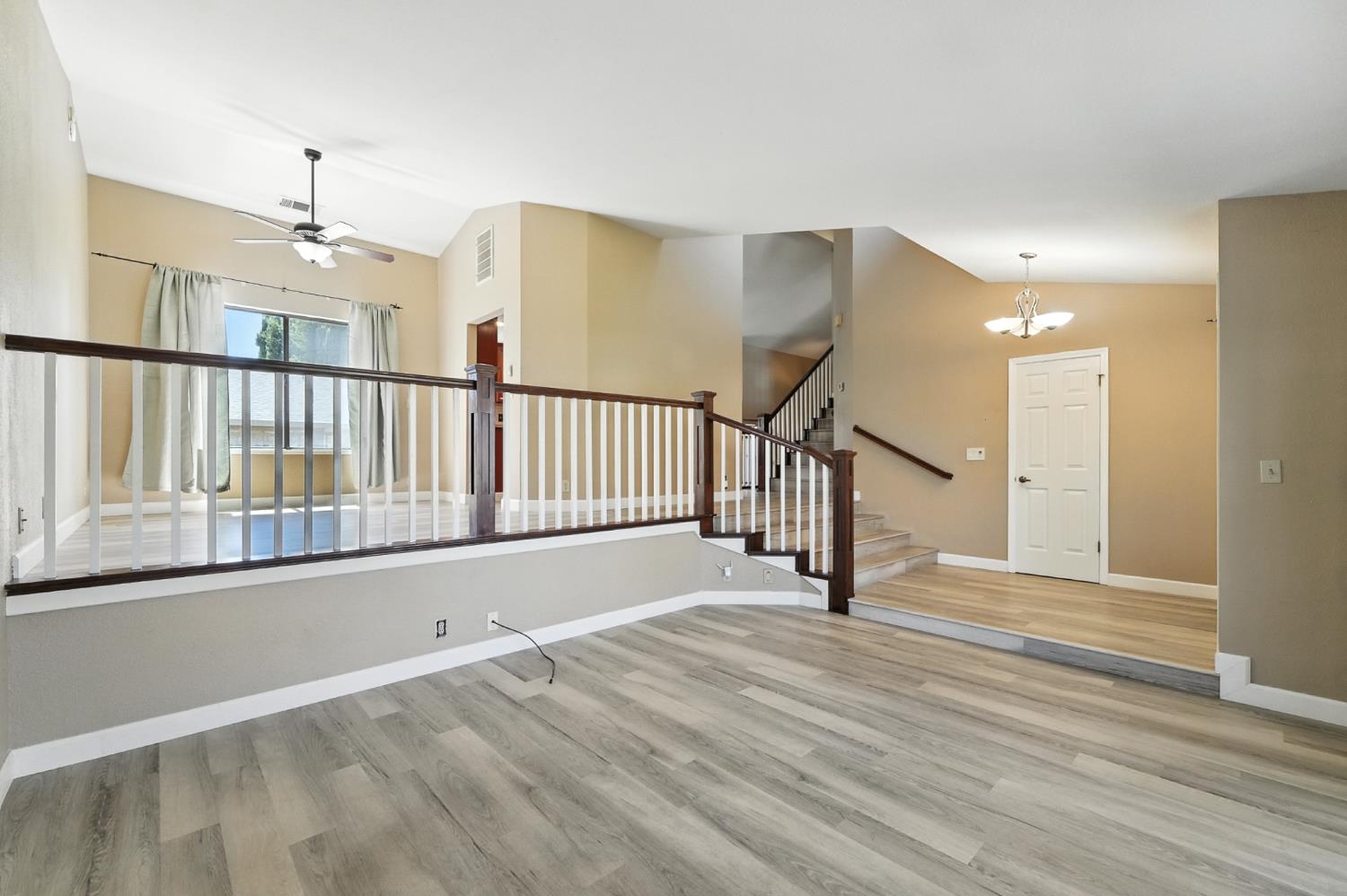 834 Cedar Ridge Drive Turlock, CA 95382 - Photo 13 of 57 a view of a hallway with wooden floor and windows