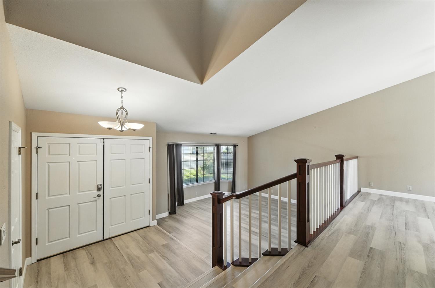 834 Cedar Ridge Drive Turlock, CA 95382 - Photo 14 of 57 a view of a hallway with wooden floor and staircase