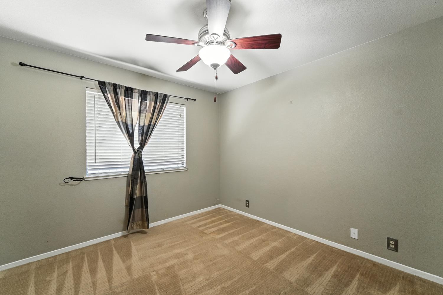 834 Cedar Ridge Drive Turlock, CA 95382 - Photo 30 of 57 an empty room with windows and fan