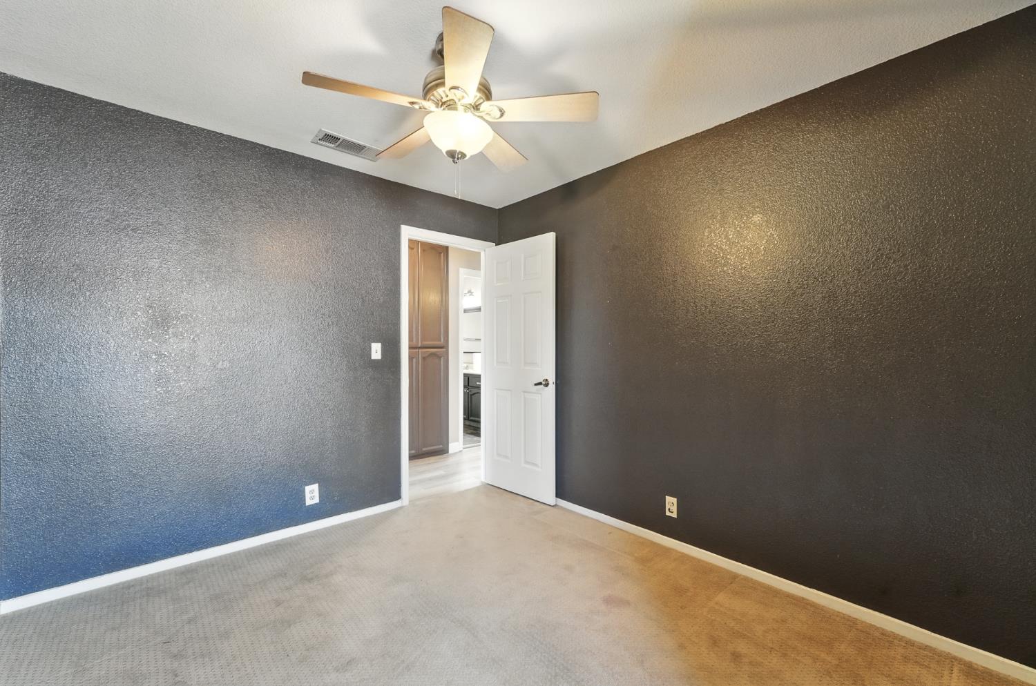 834 Cedar Ridge Drive Turlock, CA 95382 - Photo 38 of 57 a view of an empty room with a chandelier fan