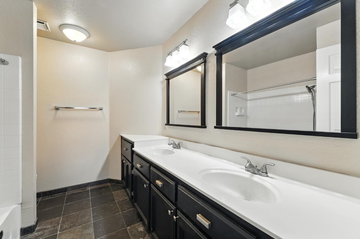 834 Cedar Ridge Drive Turlock, CA 95382 - Photo 39 of 57 a bathroom with a granite countertop sink and a mirror
