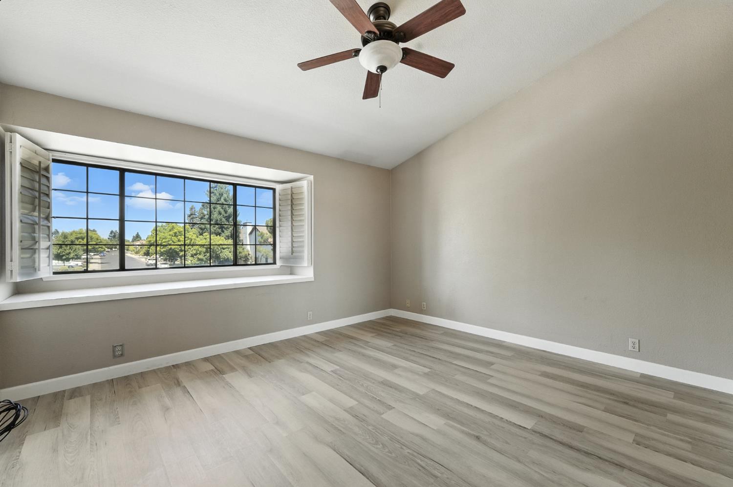 834 Cedar Ridge Drive Turlock, CA 95382 - Photo 41 of 57 a view of an empty room with a window and a ceiling fan