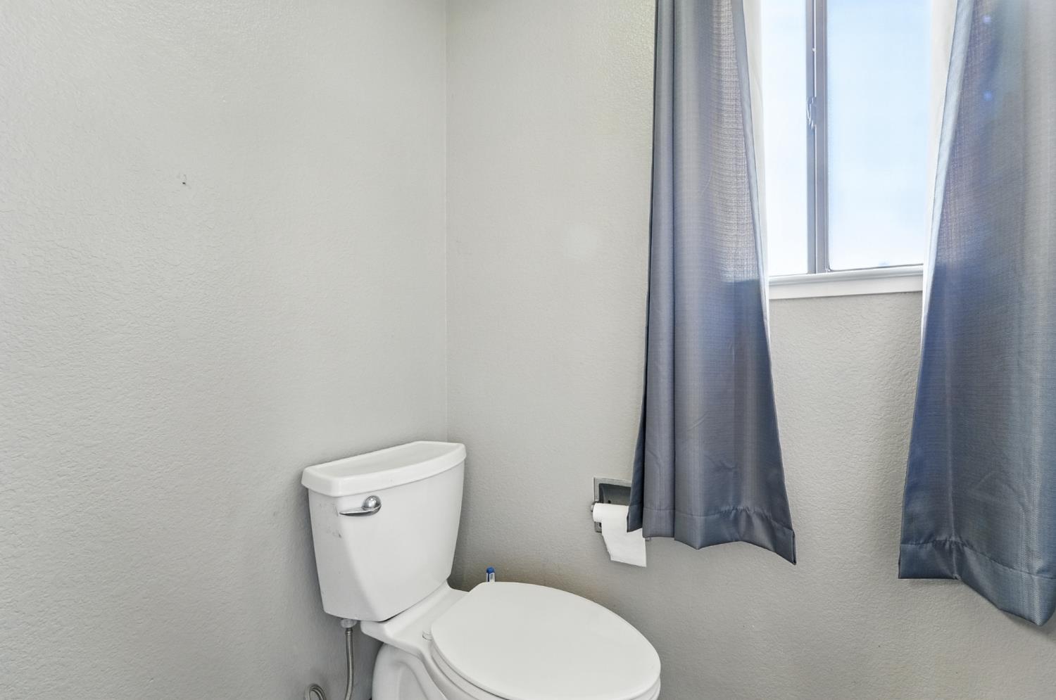 834 Cedar Ridge Drive Turlock, CA 95382 - Photo 47 of 57 a white toilet sitting next to a shower