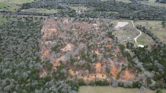 an aerial view of mountain with yard