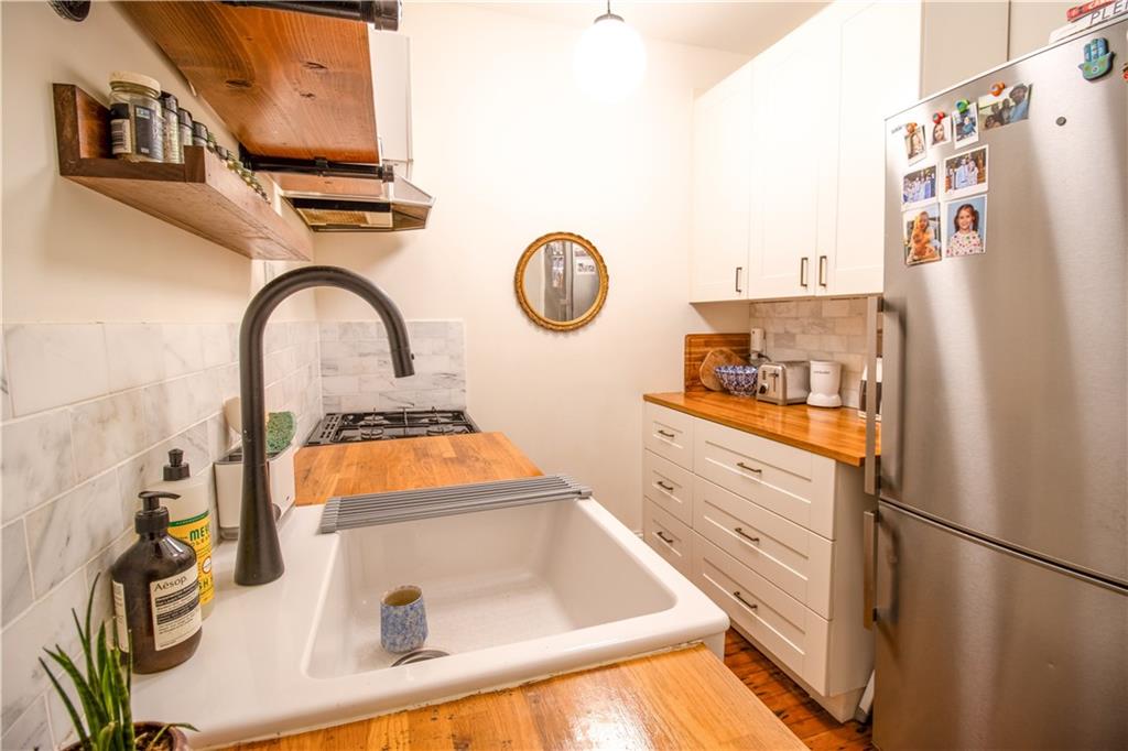 1701 Albemarle Road, Unit A10 Brooklyn, NY 11226 - Photo 5 of 16 a kitchen with stainless steel appliances granite countertop a refrigerator and a stove