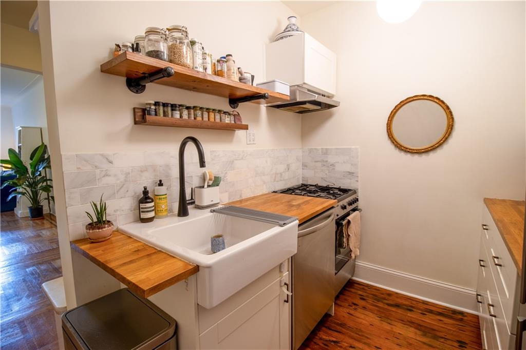 1701 Albemarle Road, Unit A10 Brooklyn, NY 11226 - Photo 6 of 16 a kitchen with a sink and a stove with wooden floor