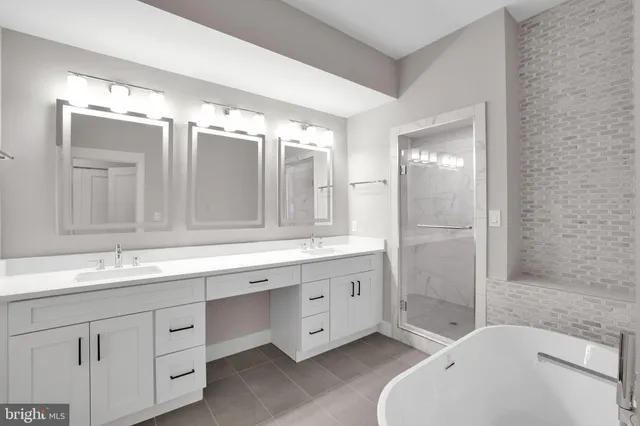 a spacious bathroom with a double vanity sink mirror double and bathtub