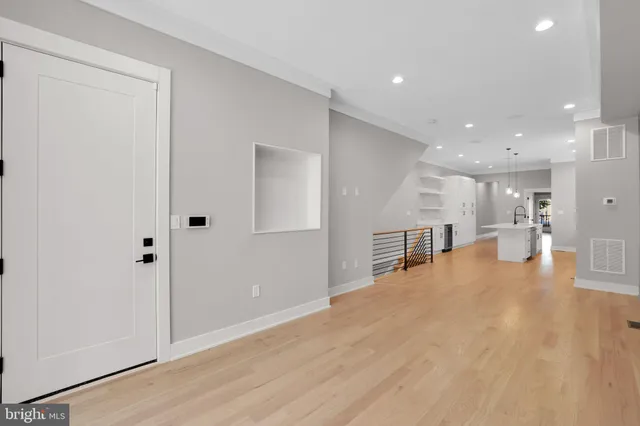 a view of a hallway with wooden floor