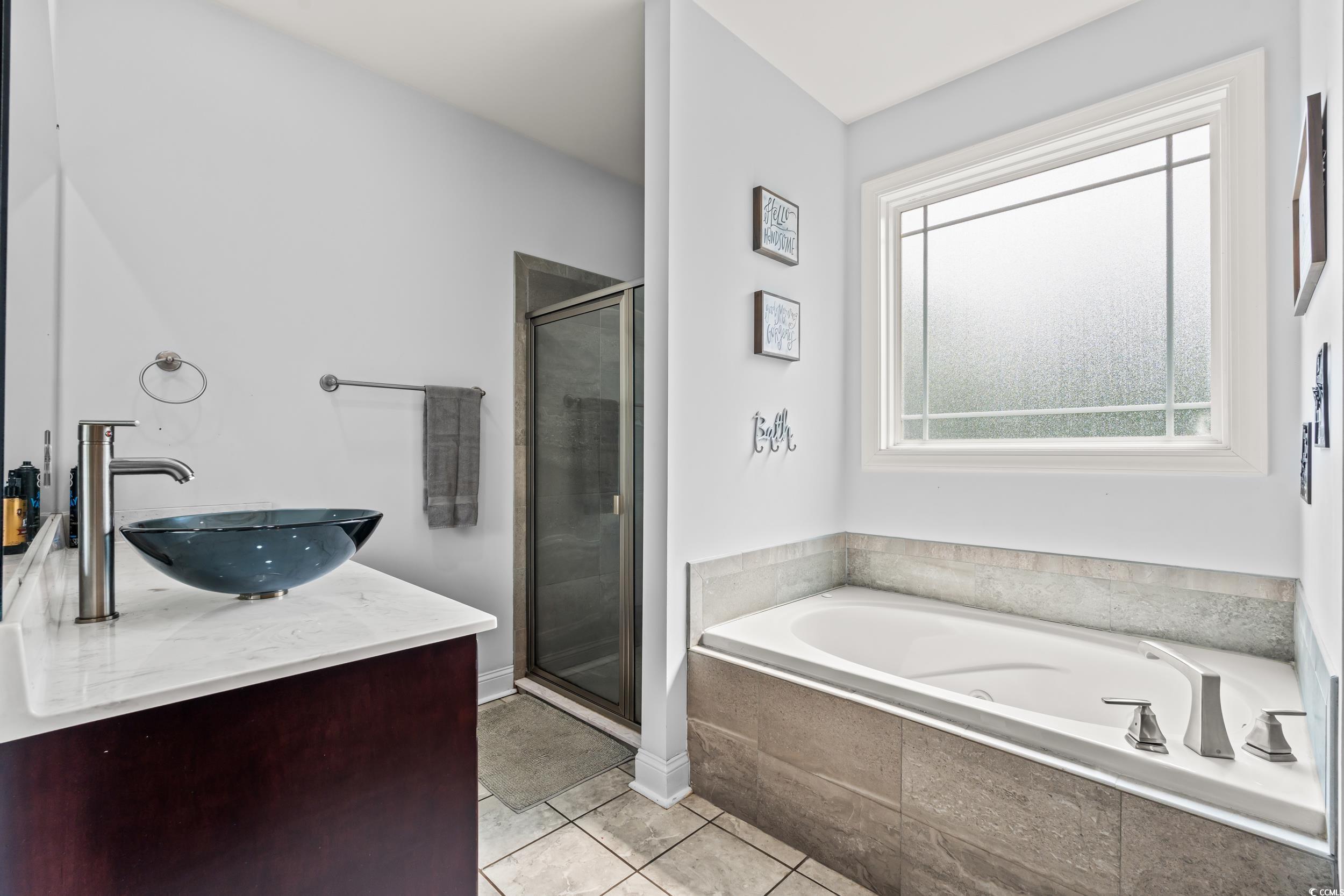 1051 Academy Drive Conway, SC 29526 - Photo 13 of 37 Bathroom with a bath, a stall shower, tile patterned flooring, and vanity