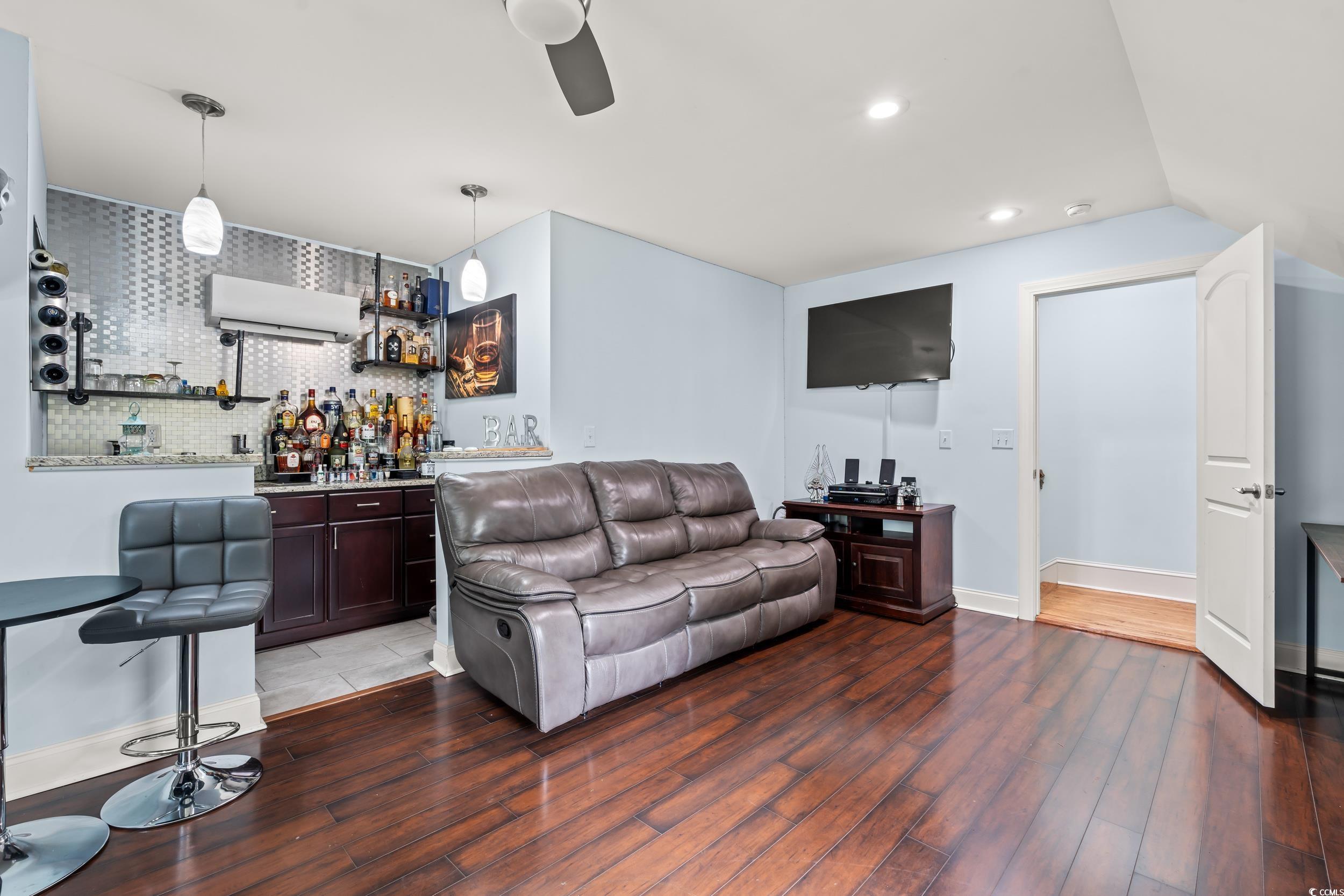 1051 Academy Drive Conway, SC 29526 - Photo 17 of 37 Living room featuring bar, wood finished floors, a ceiling fan, recessed lighting, and baseboards