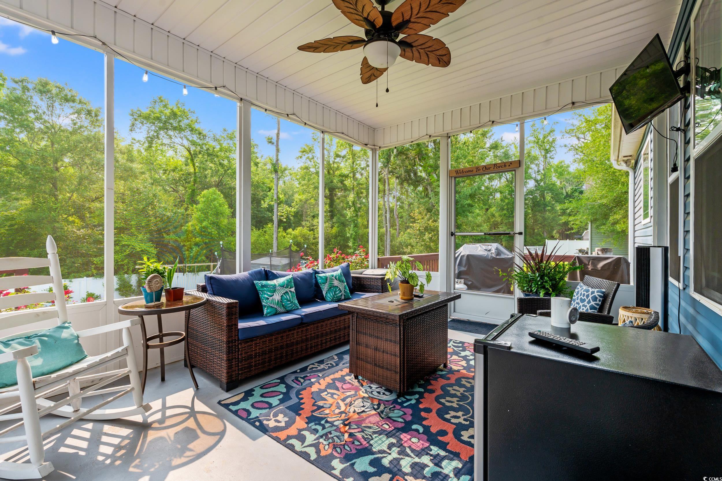 1051 Academy Drive Conway, SC 29526 - Photo 23 of 37 Sunroom with an outdoor hangout area, a ceiling fan, and view of scattered trees