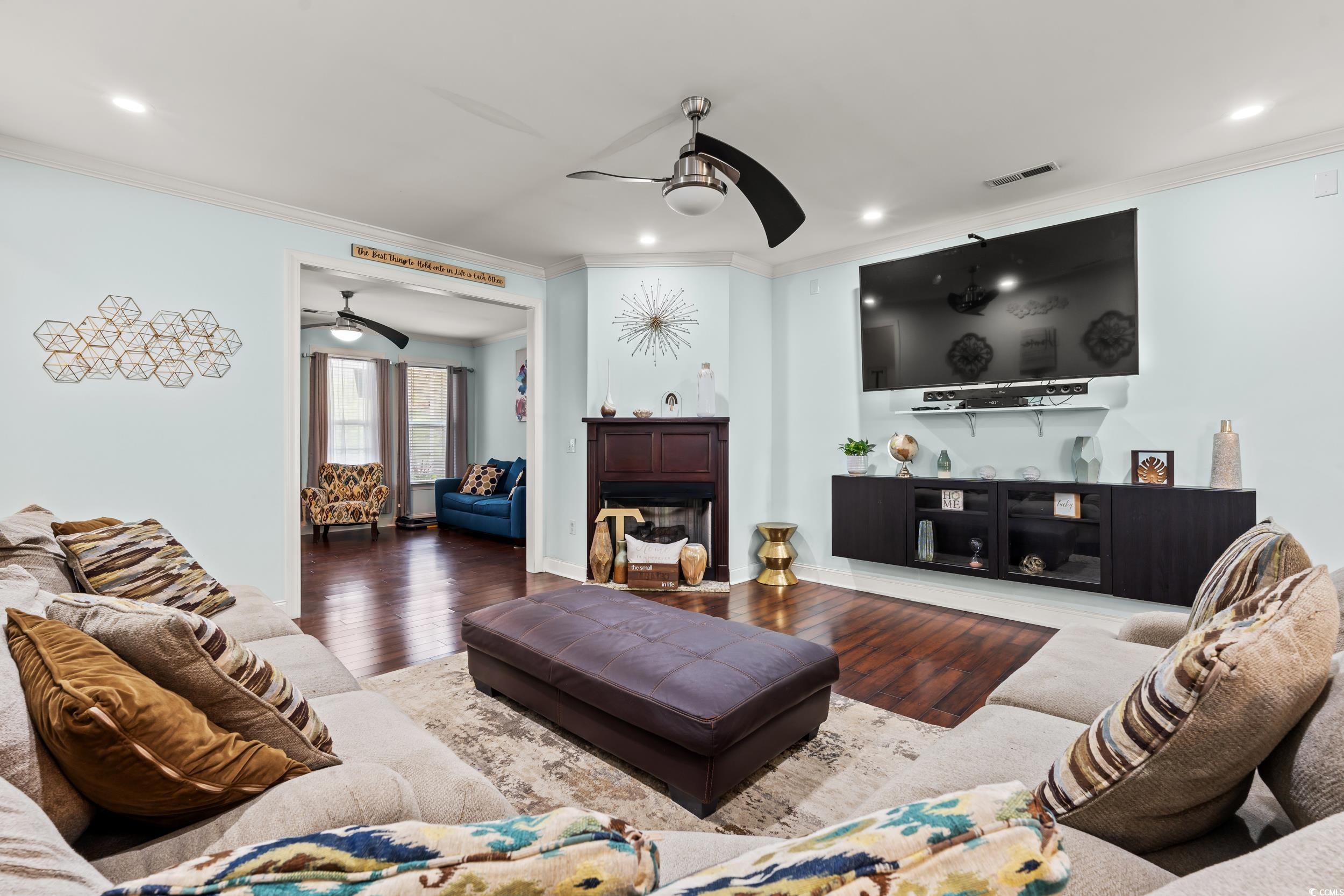 1051 Academy Drive Conway, SC 29526 - Photo 3 of 37 Living room with a ceiling fan, ornamental molding, wood finished floors, recessed lighting, and a fireplace