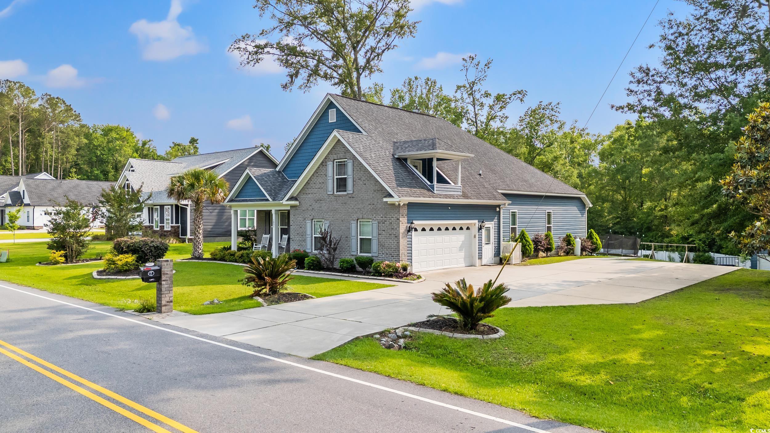 1051 Academy Drive Conway, SC 29526 - Photo 32 of 37 View of front of house featuring concrete driveway, a garage, and brick siding
