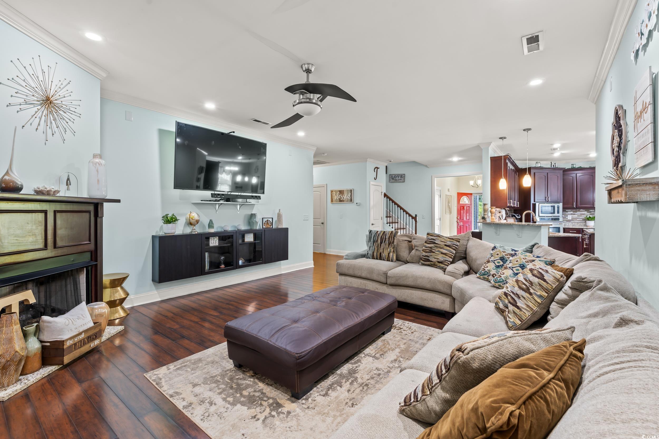 1051 Academy Drive Conway, SC 29526 - Photo 4 of 37 Living area featuring crown molding, stairway, dark wood-style floors, recessed lighting, and a ceiling fan