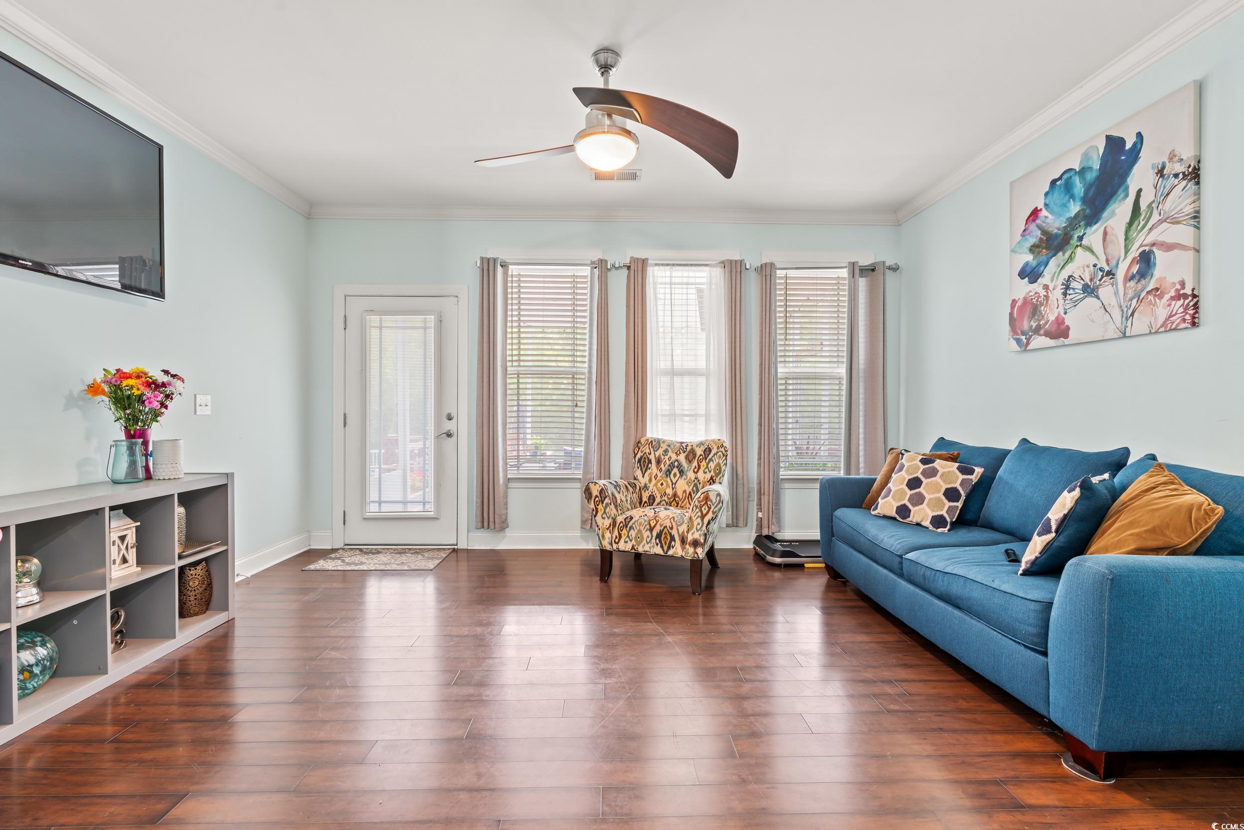1051 Academy Drive Conway, SC 29526 - Photo 7 of 37 Living area featuring crown molding, ceiling fan, hardwood / wood-style floors, and baseboards