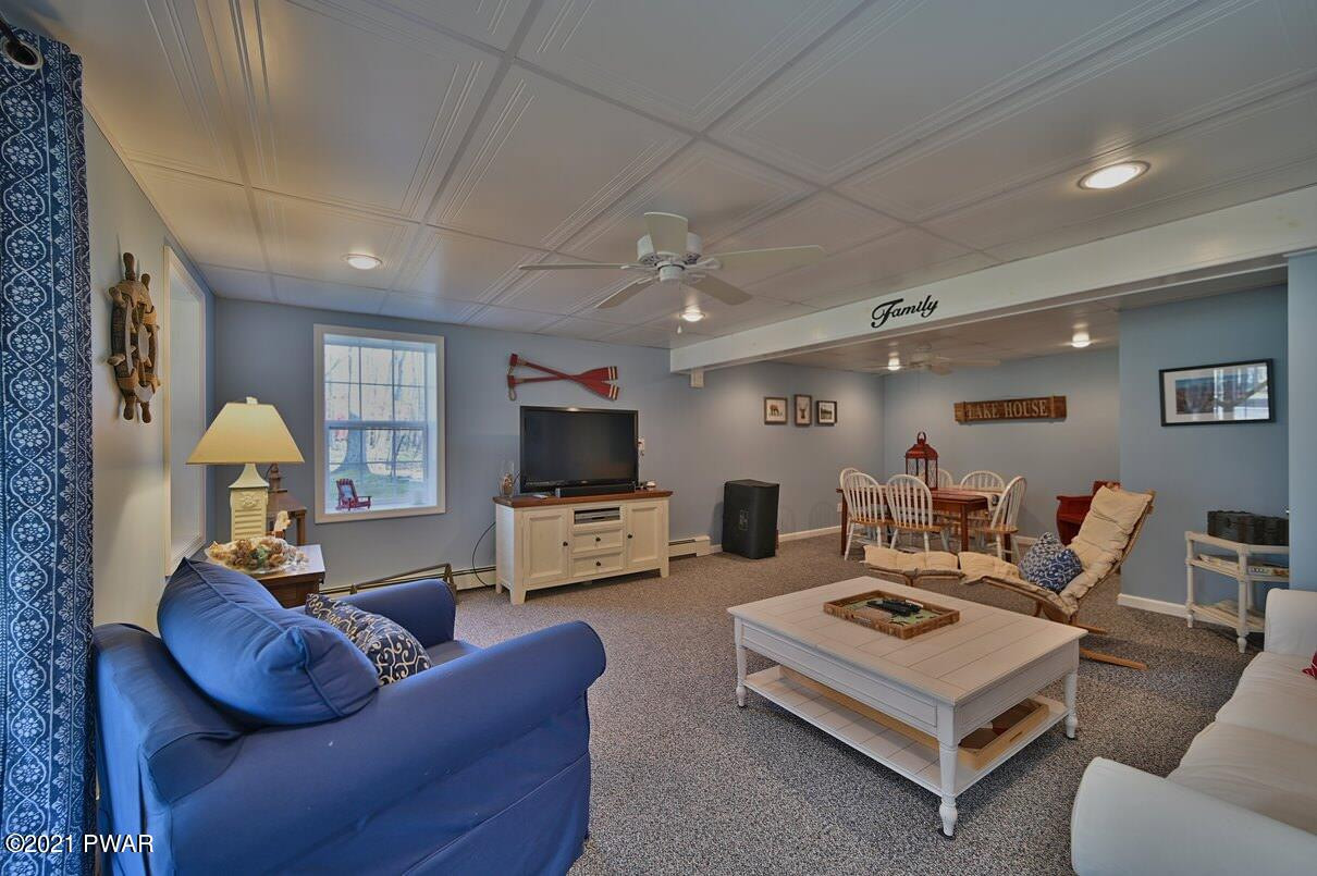 76 Rockway Road Lake Ariel, PA 18436 - Photo 67 of 101 a living room with furniture a flat screen tv and kitchen view