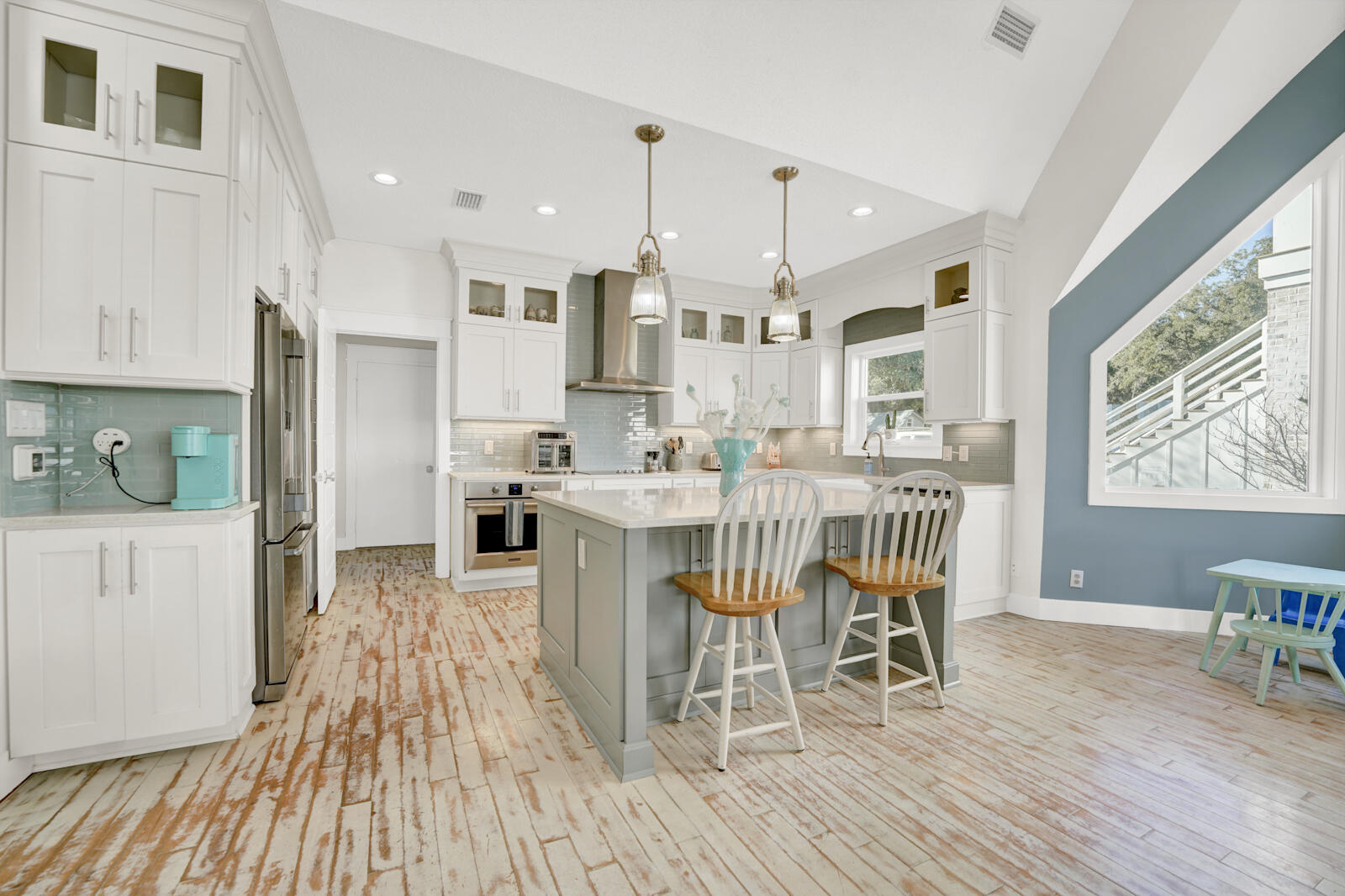 1020 Bay Grove Road Freeport, FL 32439 - Photo 4 of 71 a dining room with stainless steel appliances kitchen island granite countertop a table chairs and a wooden floor