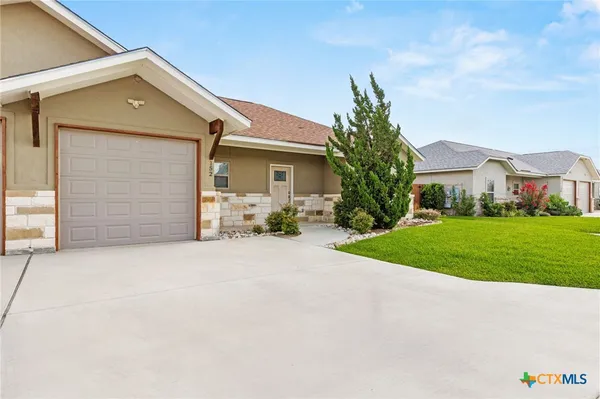a front view of house with yard and green space