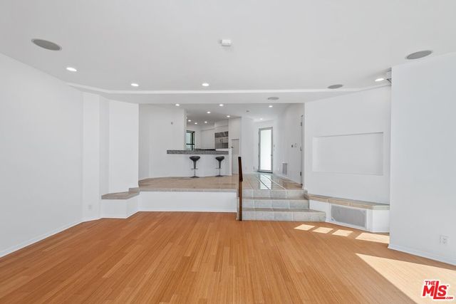 a living room with furniture fireplace and a large window