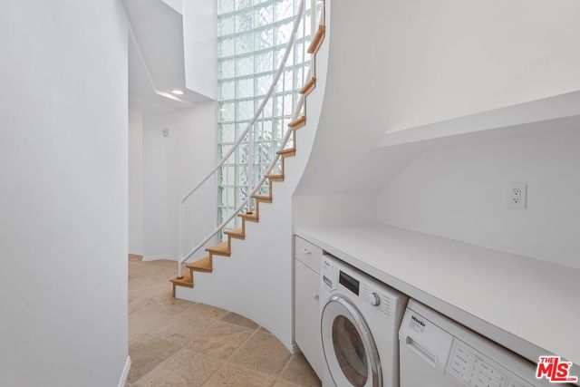 a bathroom with a shower mirror and a sink