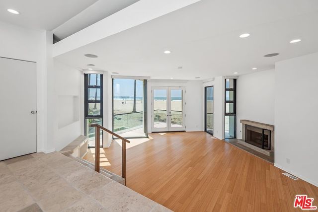 a view of kitchen with stainless steel appliances refrigerator sink and cabinets