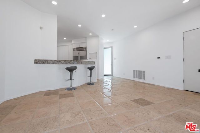 a view of a kitchen with wooden floor and a sink
