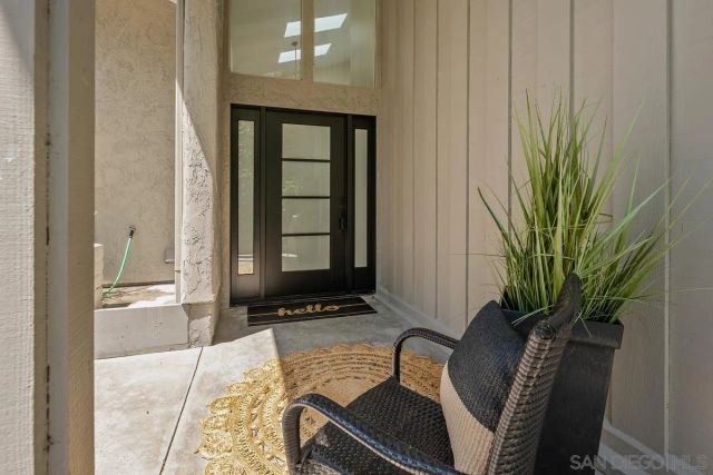 a view of a entryway with wooden floor and a potted plant