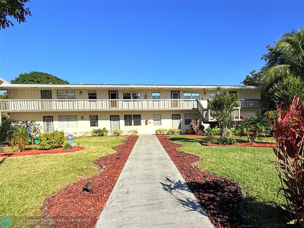 15 Markham A, Unit 15 Deerfield Beach, FL 33442 - Photo 1 of 45 a view of house with swimming pool and green space